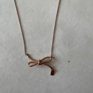 Bow coach gold necklace